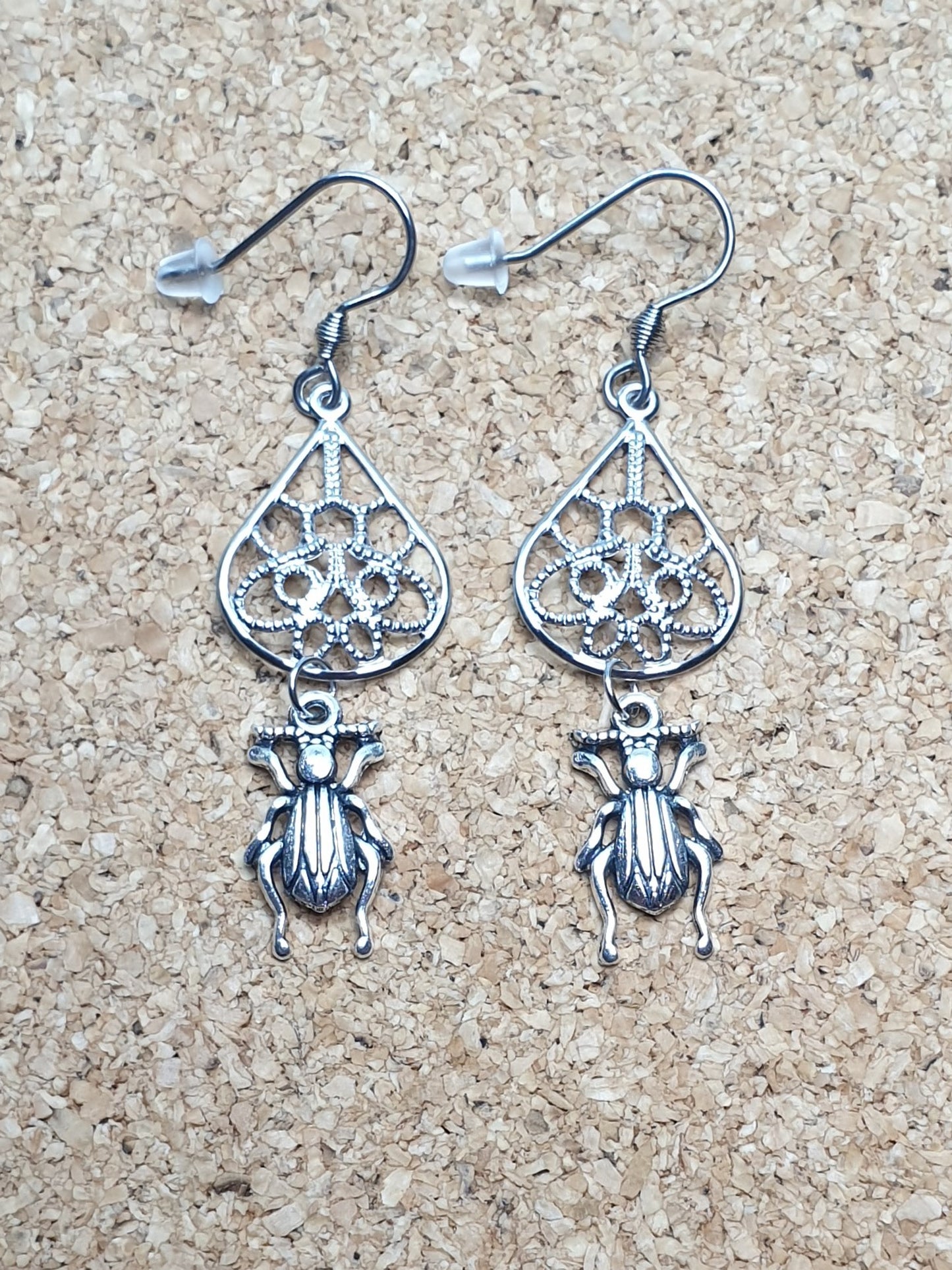 Tiny ground beetle on drop earrings