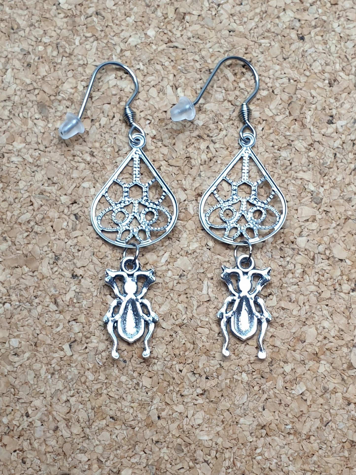 Tiny ground beetle on drop earrings