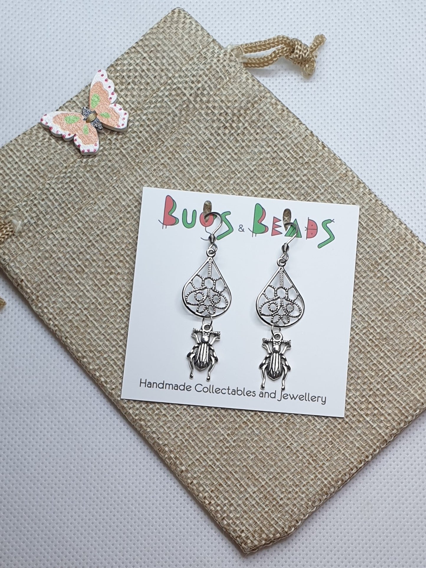 Tiny ground beetle on drop earrings