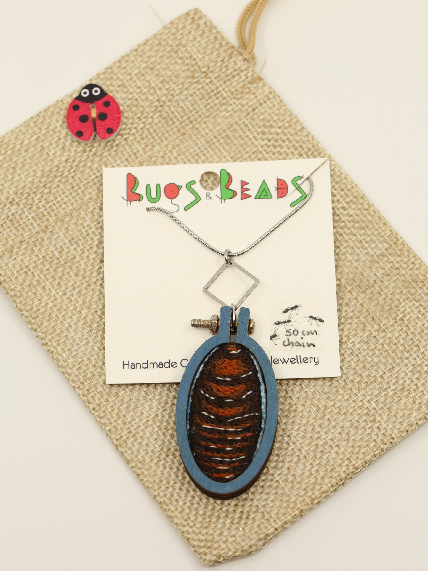 Burrowing cockroach embroidered necklace