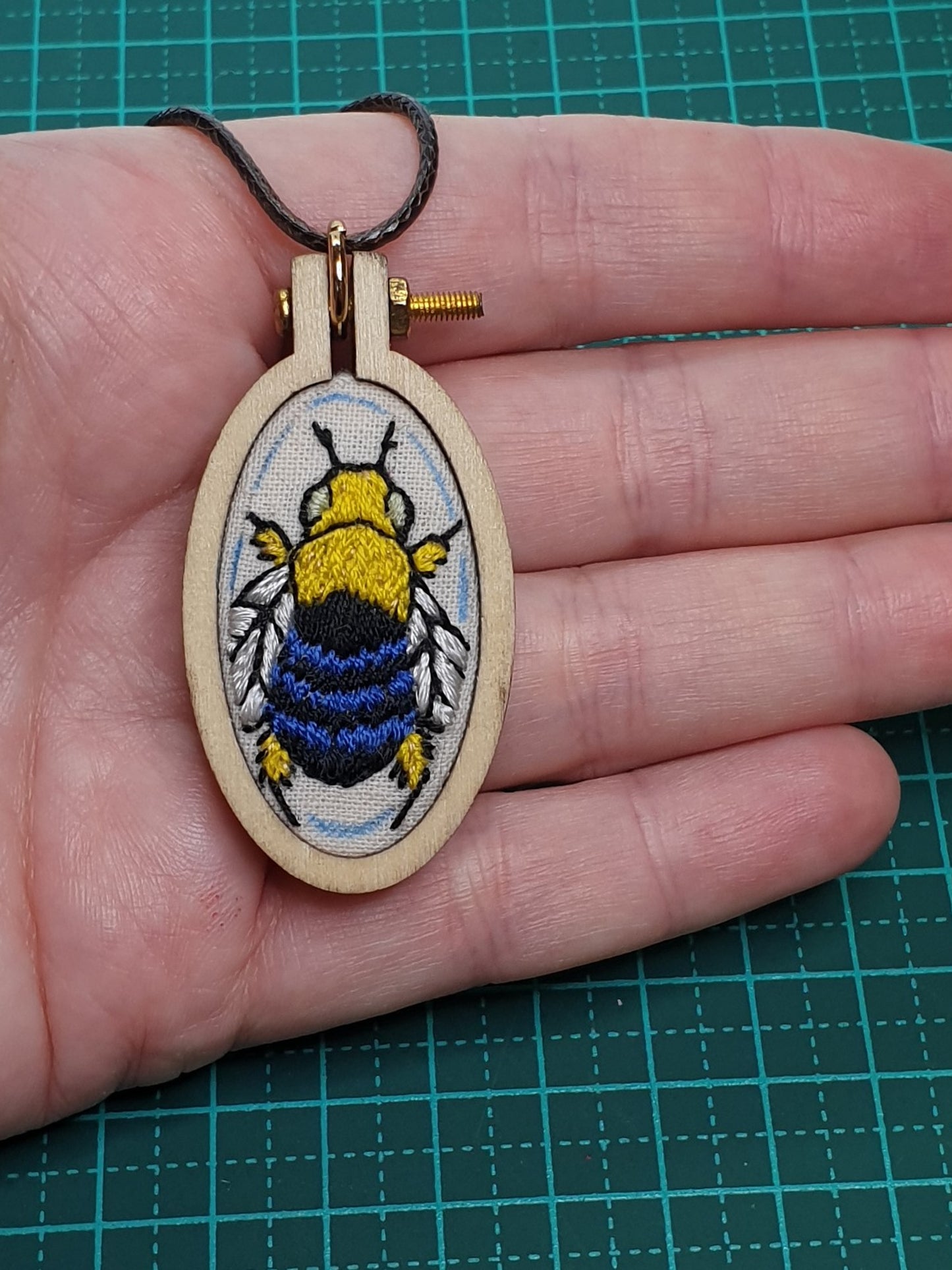 Blue Banded Bee hand embroidered pendant